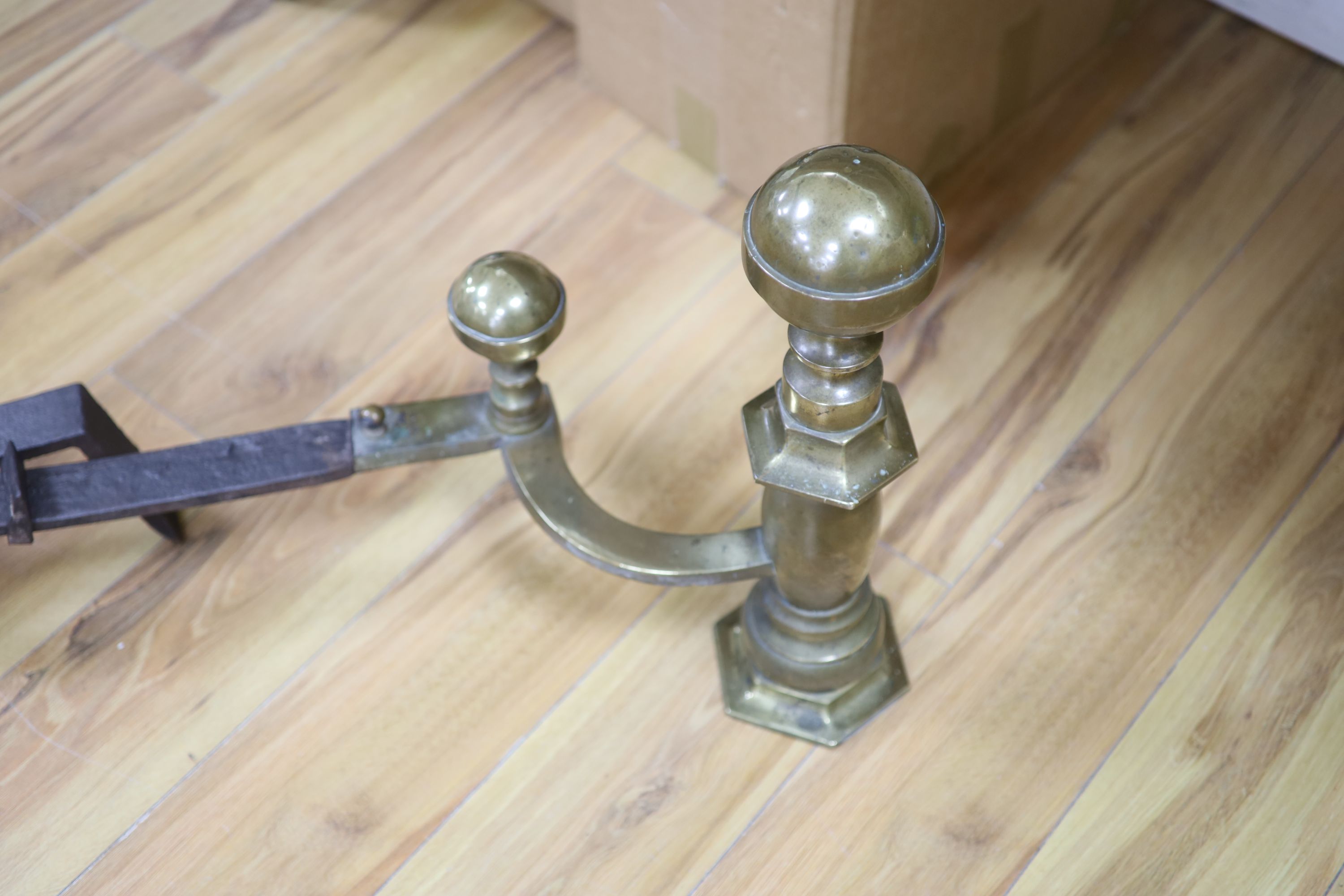 A pair of 18th century brass and wrought iron fire andirons